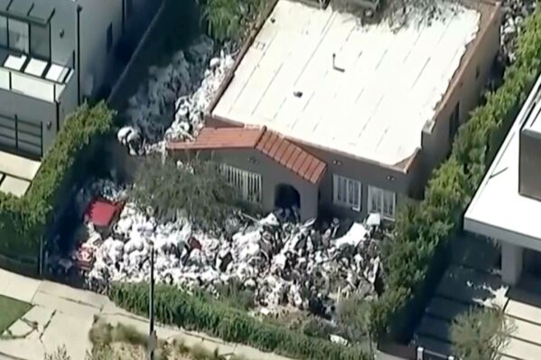 Cleanup begins at Los Angeles ‘trash house’ where entire property is filled with garbage and junk