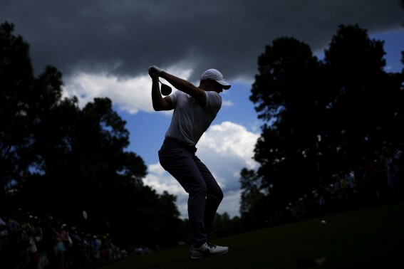 AP photographer gets in the right spot for a big swing at the Masters