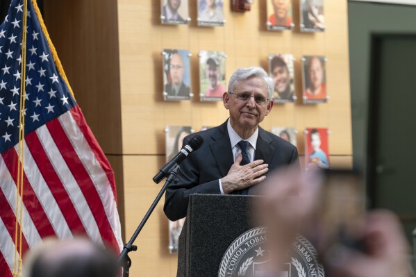 Garland speaks with victims’ families as new exhibit highlights the faces of gun violence