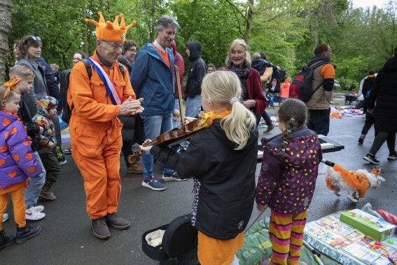 Orange crush: Boats packed with revelers tour Amsterdam canals celebrating the king’s birthday