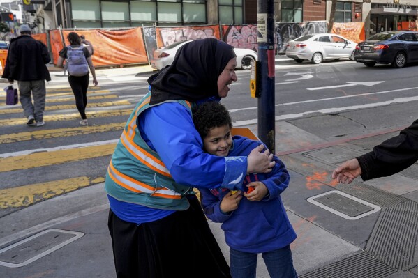 With a vest and a voice, helpers escort kids through San Francisco’s broken Tenderloin streets