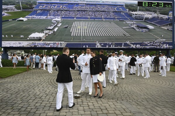 Defense secretary tells US Naval Academy graduates they will lead ‘through tension and uncertainty’