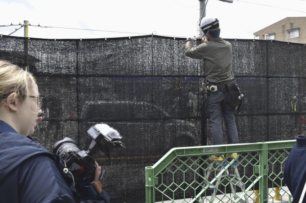 A Japanese town finds holes in a screen built to prevent tourists from snapping photos of Mount Fuji