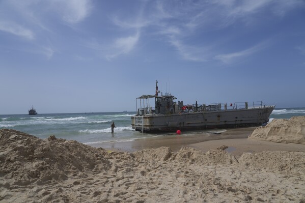 Aid deliveries suspended after rough seas damage US-built temporary pier in Gaza, 3 US officials say