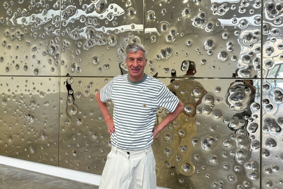 Gold and gunfire: Italian artist Cattelan’s latest satirical work is a bullet-riddled golden wall