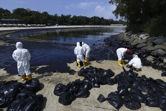 Singapore says dredger that hit tanker reported sudden loss of control, oil spill cleanup ongoing