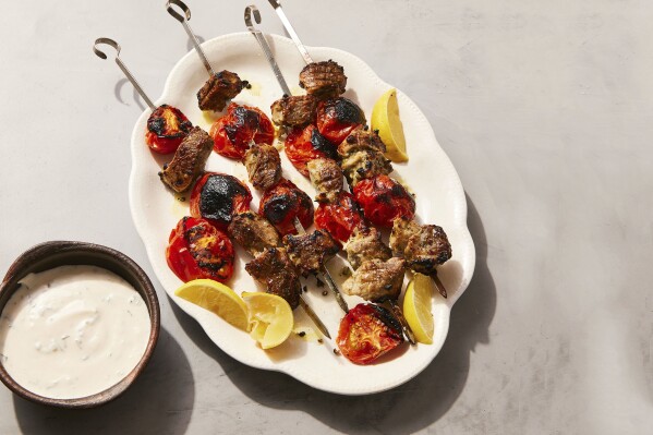 A garlicky yogurt marinade pulls double duty in souvlaki-inspired pork skewers