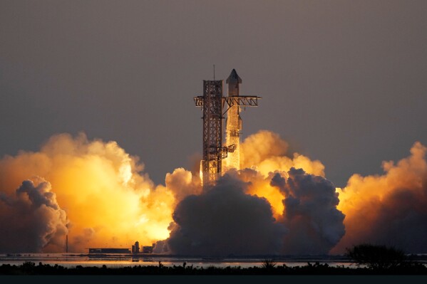 In an engineering feat, mechanical SpaceX arms catch Starship rocket booster at landing pad