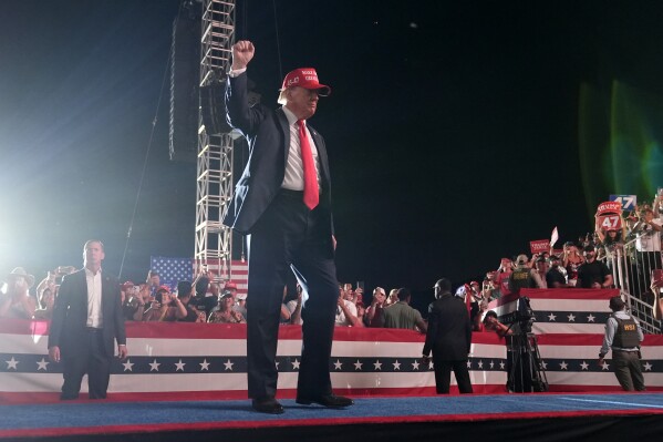 A man arrested with guns outside a Trump rally in California is suing the sheriff