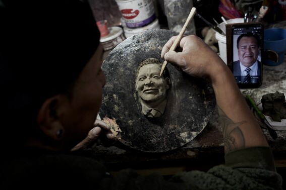 A Bolivian artist carves faces of the departed onto Day of the Dead bread